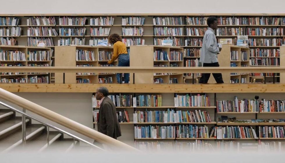 People browsing the shelves of a public library